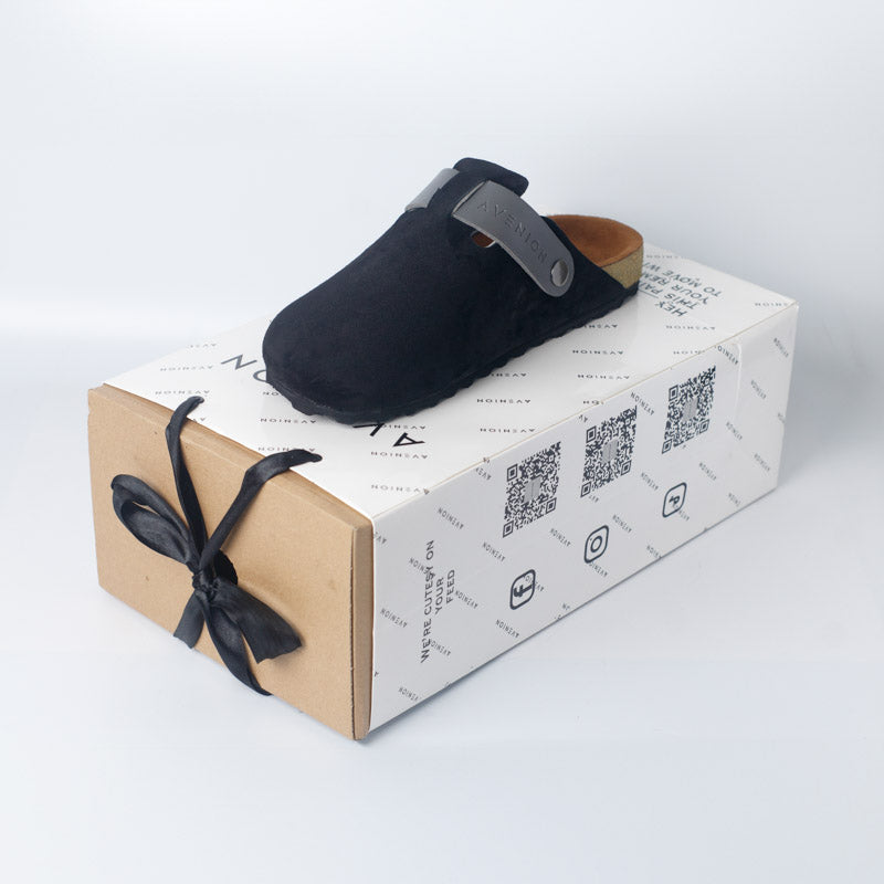 Black slipper on a branded box with a white background