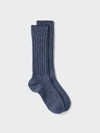 Pair of blue socks on a light gray background
